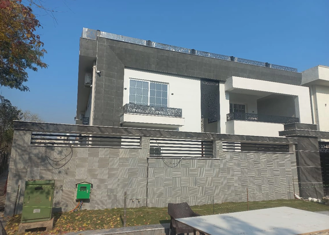 modern house exterior with textured boundary wall by hescon engineering