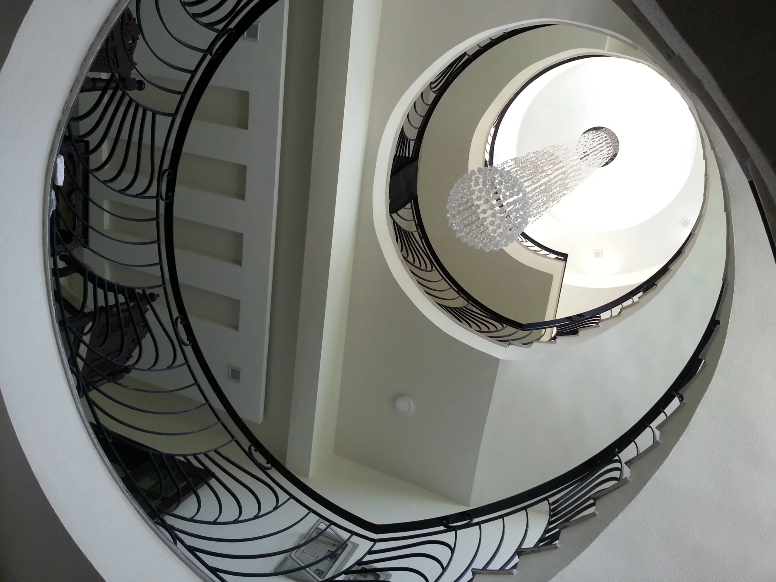 elegant curved staircase railing with intricate design by hescone engineering