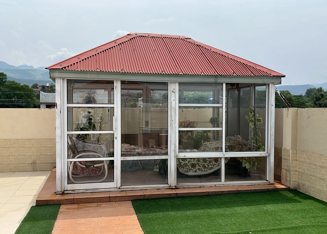 glass sunroom with red roof by hescone engineering