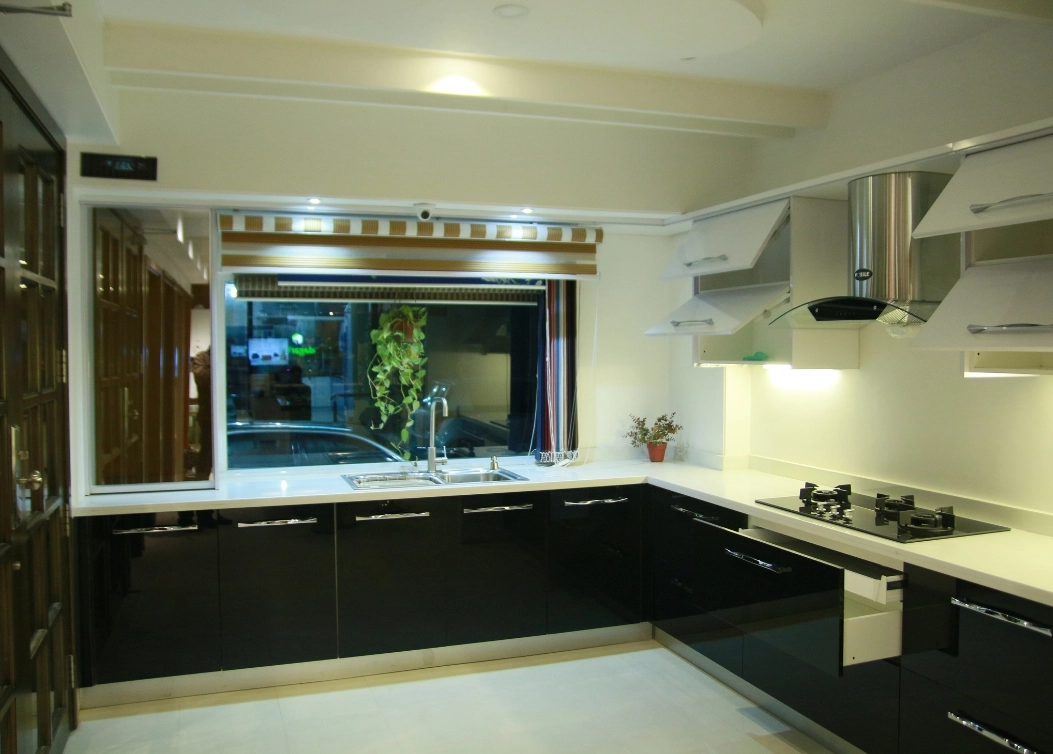 modern black gloss kitchen with white countertops and large window by hescone engineering