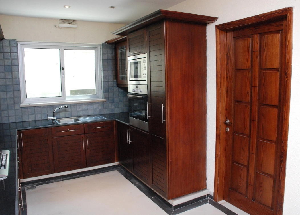 modern dark wood kitchen with integrated appliances by hescone engineering