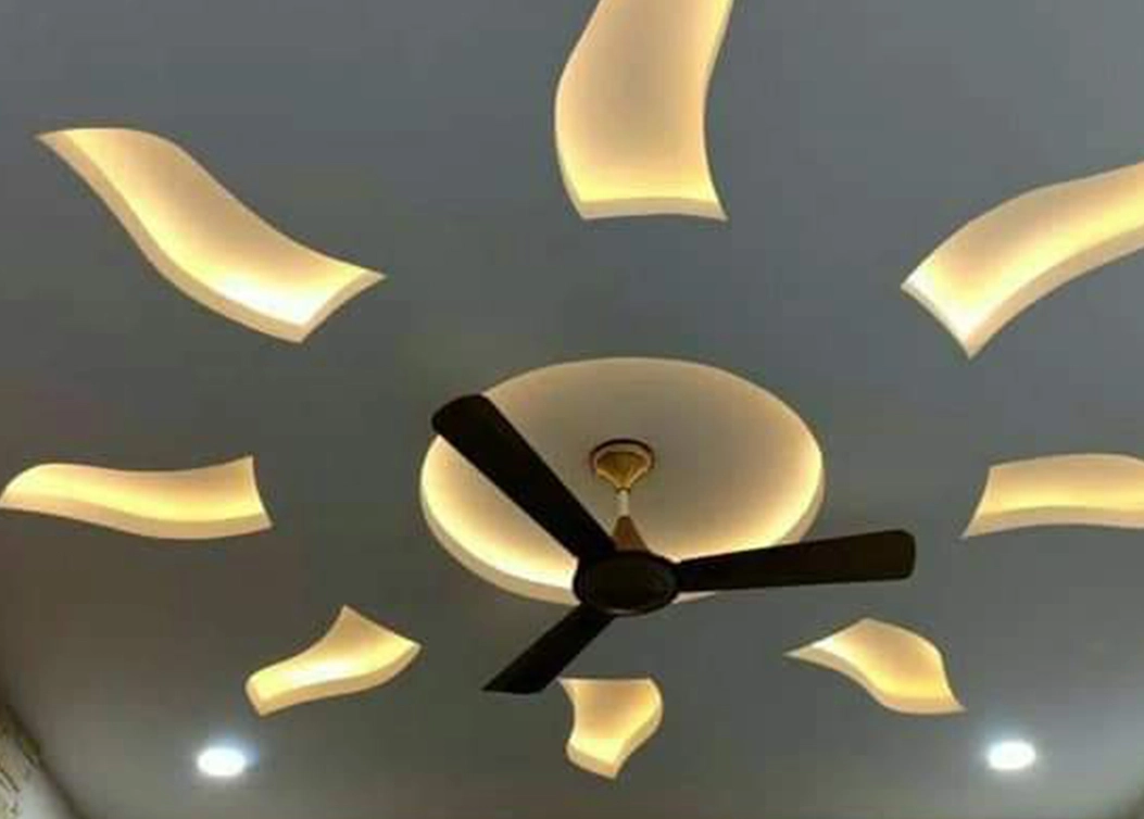 pop false ceiling with wavy lighting around fan by hescone engineering